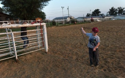 Springdale, Arkansas: Marlene and Virgil Moore keep a roping arena at their Springdale home. A child practices his cowboying skills.