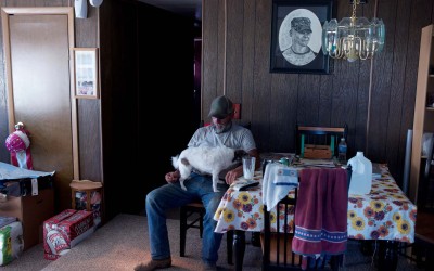 Hay Springs, Nebraska August 31. 2012  Jim Mracek sits in the living room of his trailer during another rainless day of 102 degree tempertures. Jim is a caretaker on a 5,000 acre cattle ranch in Western Nebraska. A drawing of his son, Cory, who was killed in Iraq, hangs on the wall.
