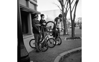 Teenagers with bicycles.