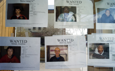 Wanted posters taped on the window of the Allen County Sheriff's Office, a storefront in downtown Lima. It is not stated on each notice what each person is wanted for, but requests that the Allen County Probation Department be notified.