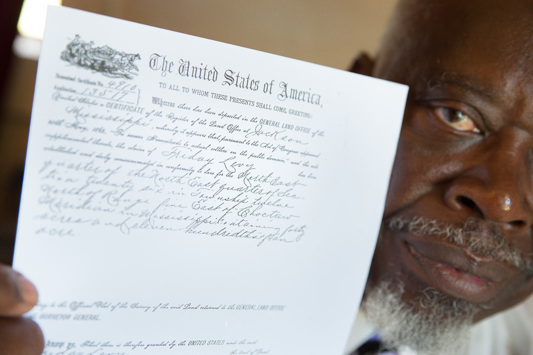 William Primer shows a copy of papers his fourth great-grandfather, Friday Levey,  signed for forty acres of land during Reconstruction. 
