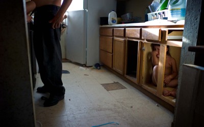 Crying in the kitchen cupboard, Allen, Pine Ridge Reservation.  Over 90 percent of Pine Ridge residents live below the federal poverty line, and the unemployment rate hovers between 85 and 90 percent.