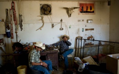 John Neumann and Colten Triebwasser take a break from cutting hay and vaccinating cattle on the Neumann ranch near Cactus Flat, South Dakota.