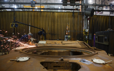 Welding on top of hull of an Abrams tank.